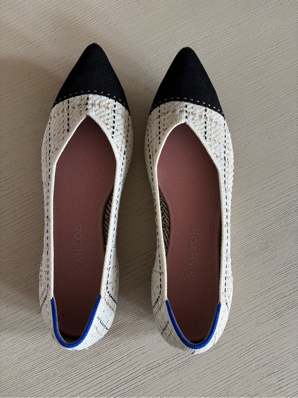 Rothy's Two-Tone Pointed Flats in Cream and Black with Blue Trim